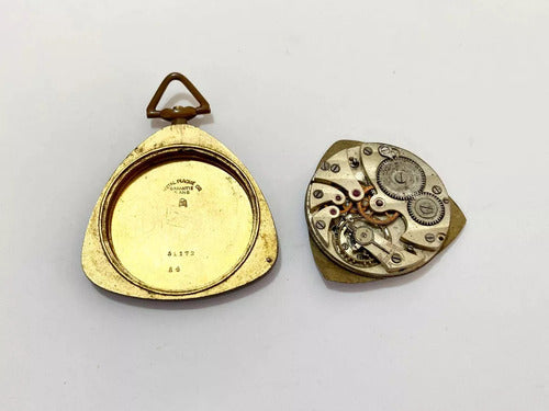 Antique pocket watch parts showing inner mechanical gears and gold-toned case separated on white background